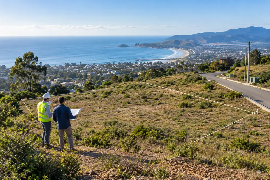 Surveyor and investor reviewing a coastal development parcel