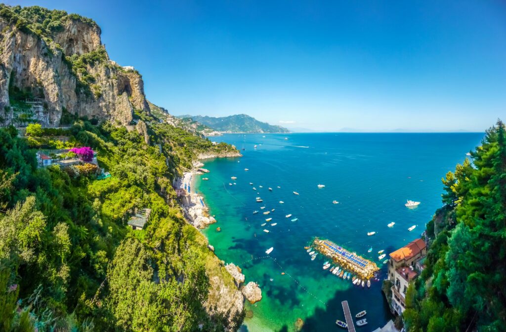 A view of the Amalfi Coast, with cliffs and blue sea.