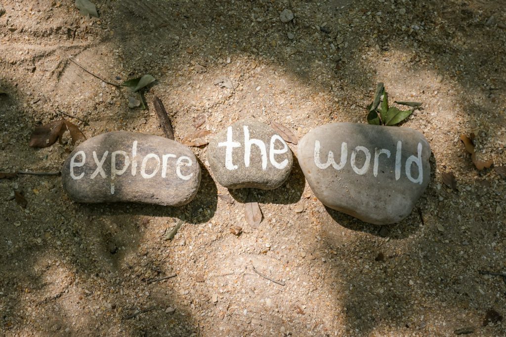 two rocks with the words explore the world written on them