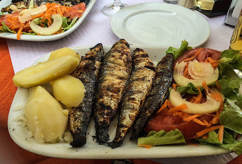Enjoy fresh seafood, like these grilled sardines, in Lisbon. Photo: Theo K