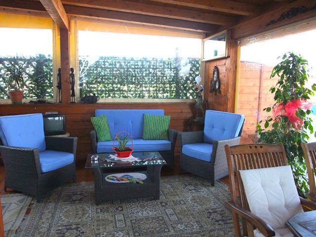 blue patio furniture in sunroom at One Step From Saint Peter, one of the best budget hotels in Rome